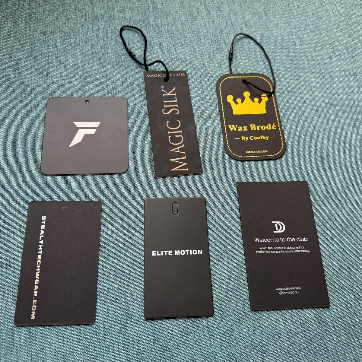 Premium foil-stamped cardboard hang tag with embossed logo